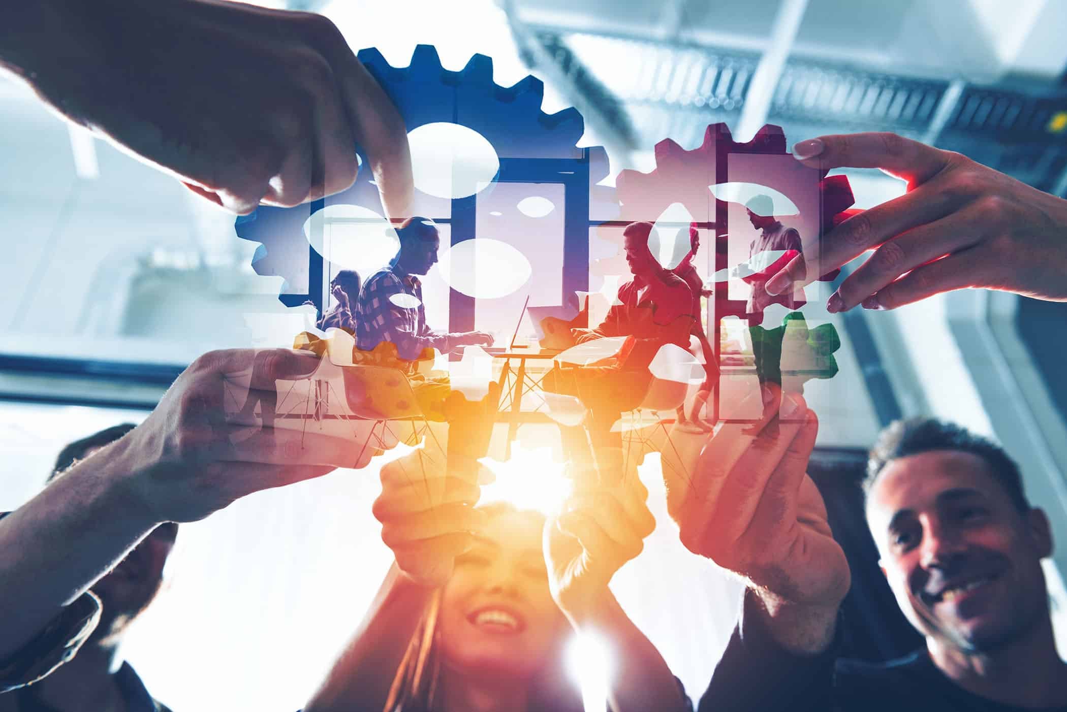 Business team connect pieces of gears. Teamwork, partnership and integration concept. double exposure with light effects